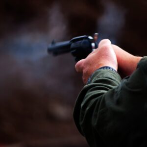 Hands firing a pistol