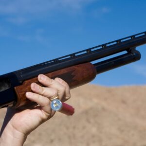 Person firing a shotgun