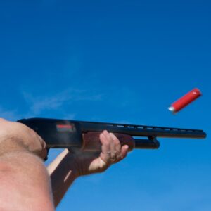 Person firing a shotgun